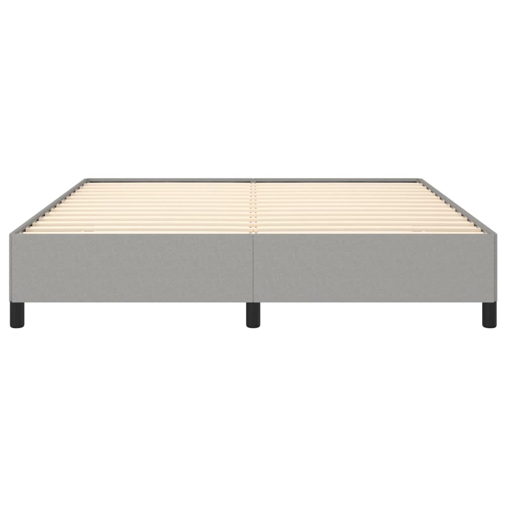 Upholstered grey bed frame with white mattress