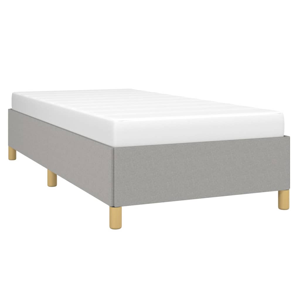Grey fabric single bed frame with white mattress and wooden legs