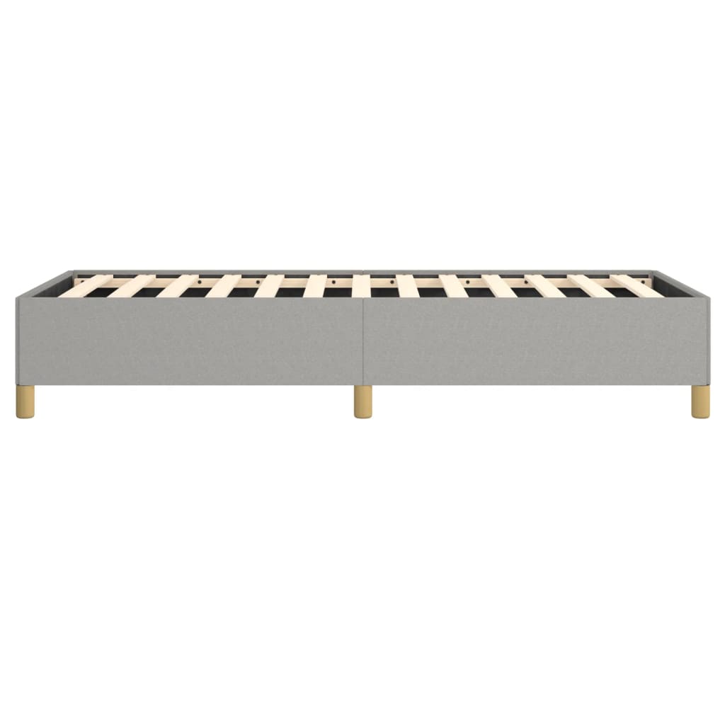 Grey upholstered twin bed frame with wooden slats and gold legs