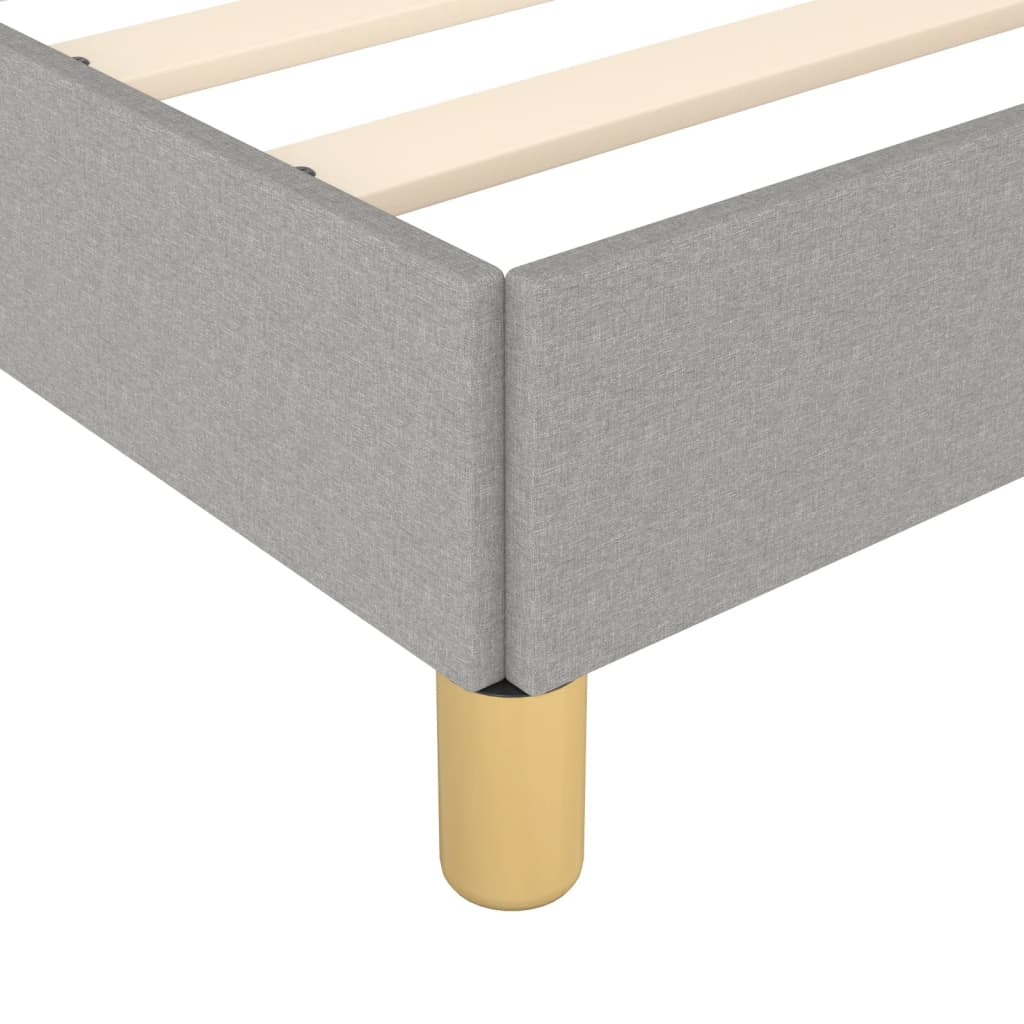 Modern grey upholstered bed frame with wooden slats and gold legs