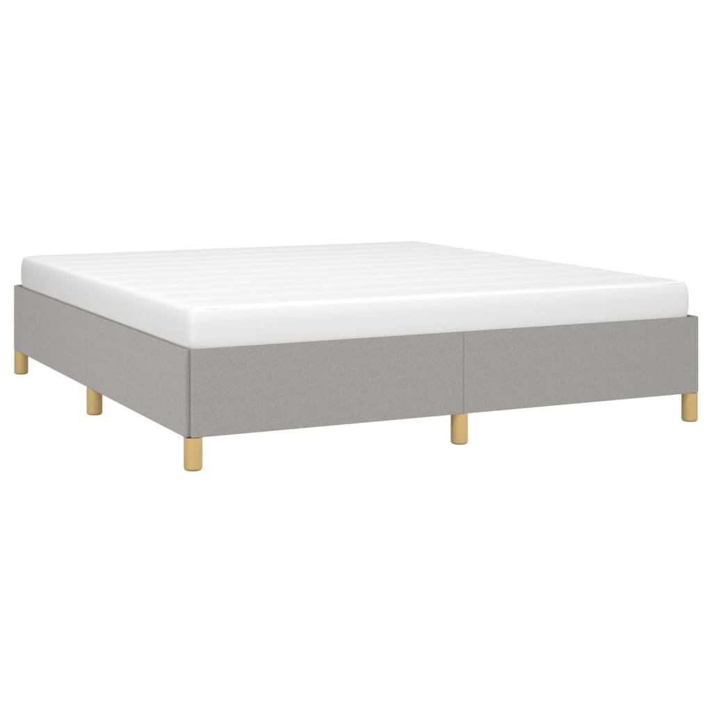 Light gray fabric bed frame with white mattress and wooden legs