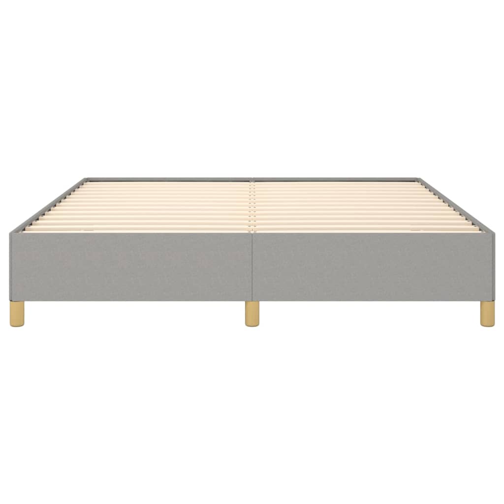Modern grey upholstered bed frame with white mattress on gold legs