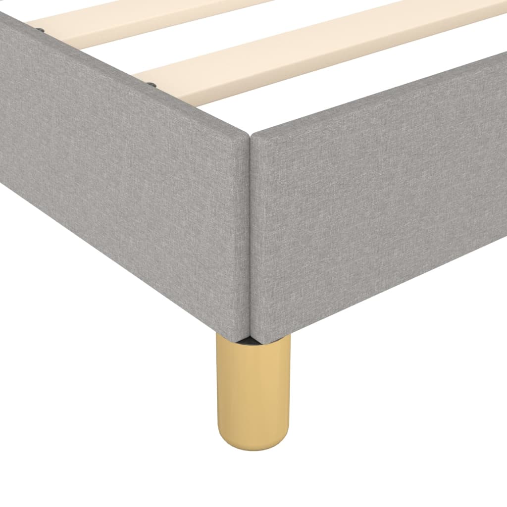 Modern grey upholstered bed frame with wooden slats and gold legs