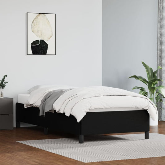 Modern dark grey upholstered platform bed frame with white bedding and grey throw blanket