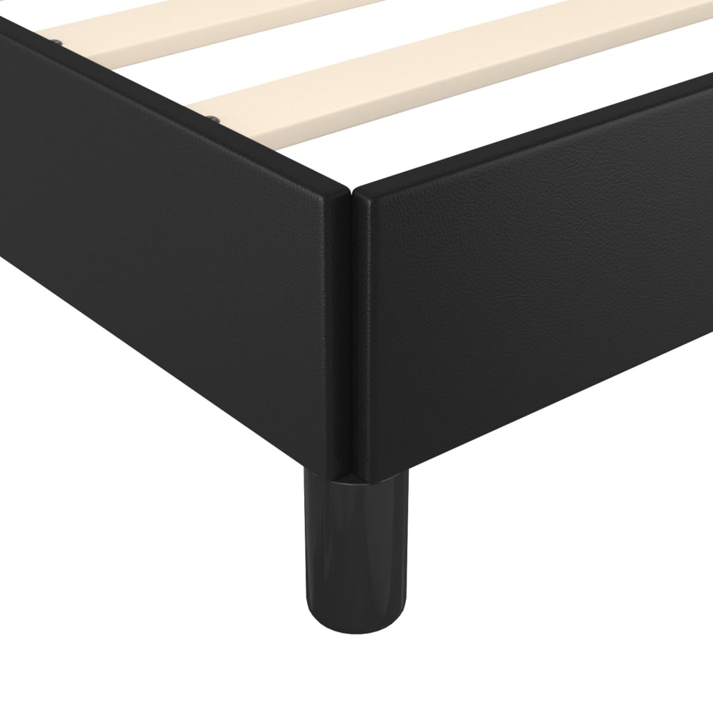 Black upholstered platform bed frame with wooden slats