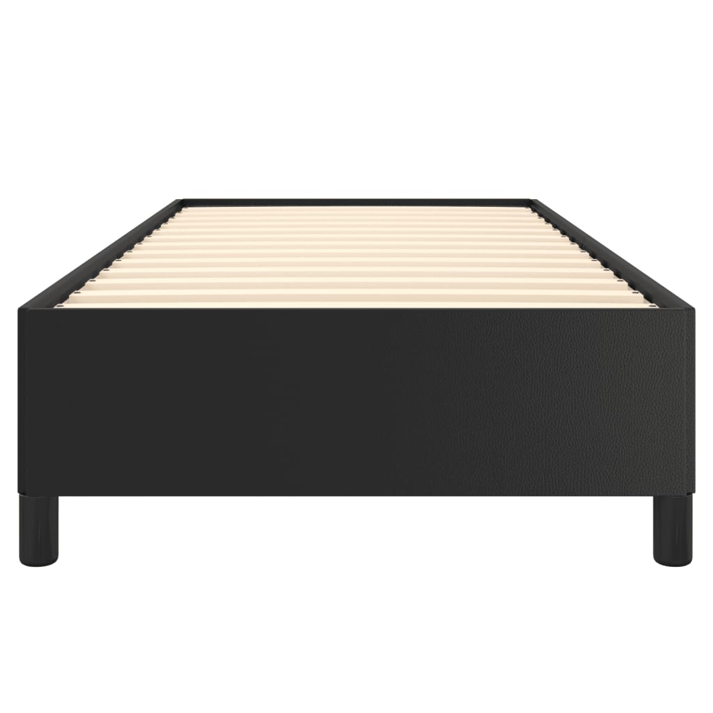 Black upholstered twin bed frame with white mattress and wooden legs