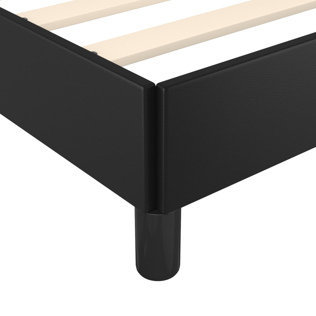 Black upholstered twin bed frame with wooden slats and short cylindrical legs