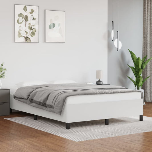 White upholstered twin bed frame with a quilted grey throw blanket