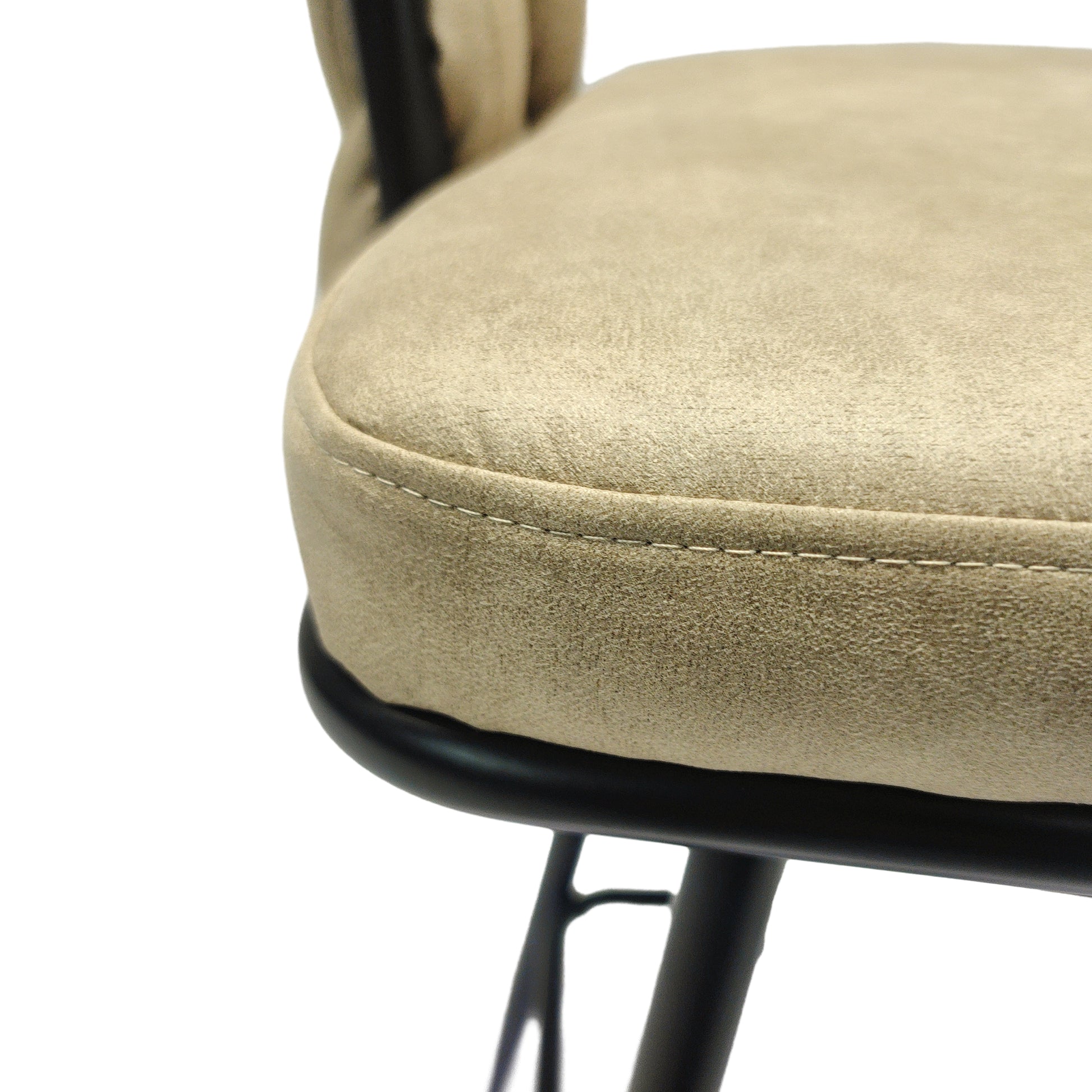 Closeup of beige suede fabric seat cushion with visible stitching on a black metal frame bar stool