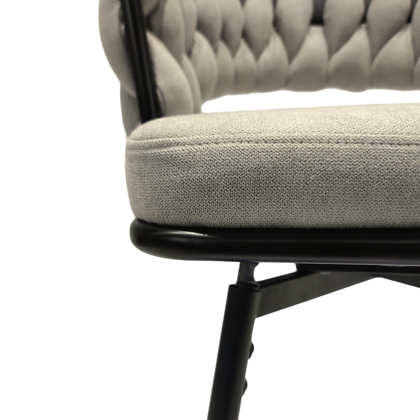 Gray tufted upholstered chair seat and back detail with black metal frame