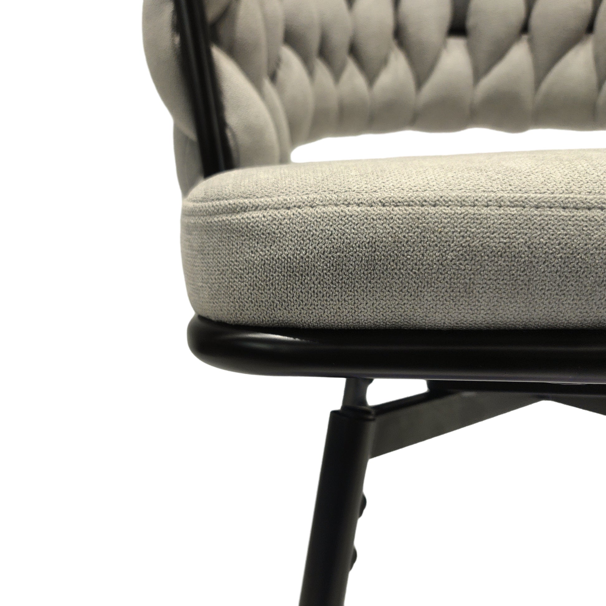 Gray tufted upholstered chair seat and back detail with black metal frame