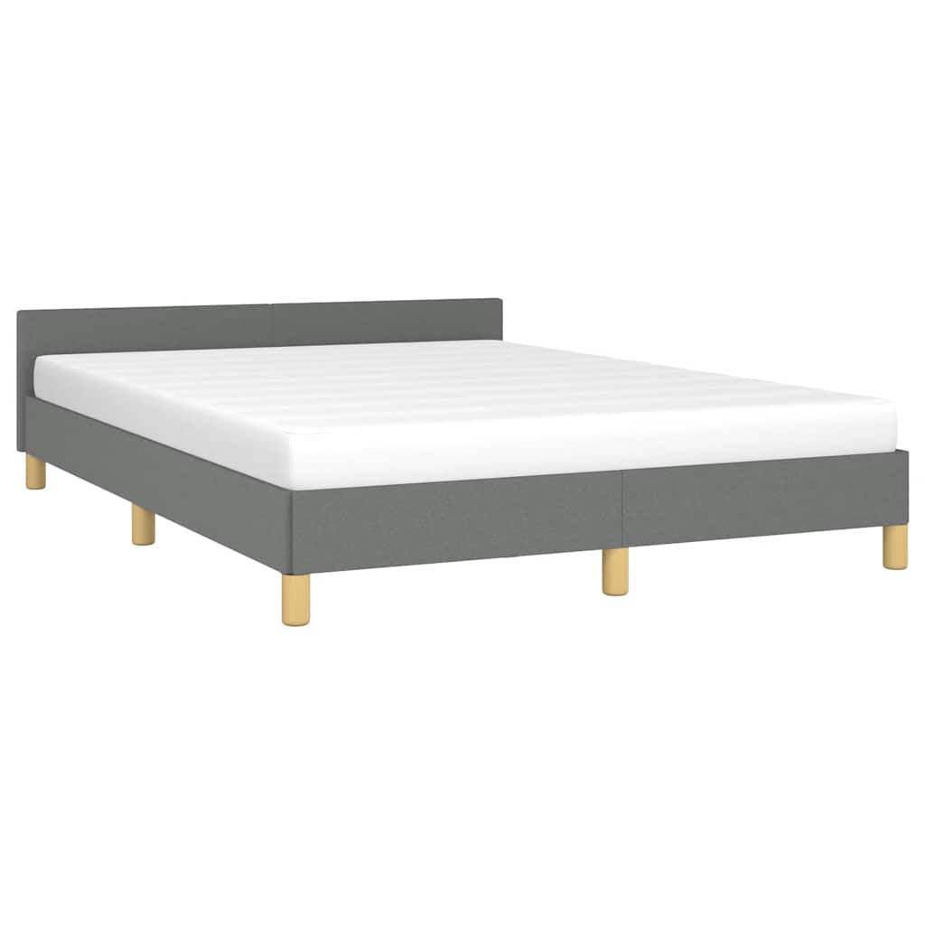 Upholstered grey bed frame with a white mattress and light wood legs