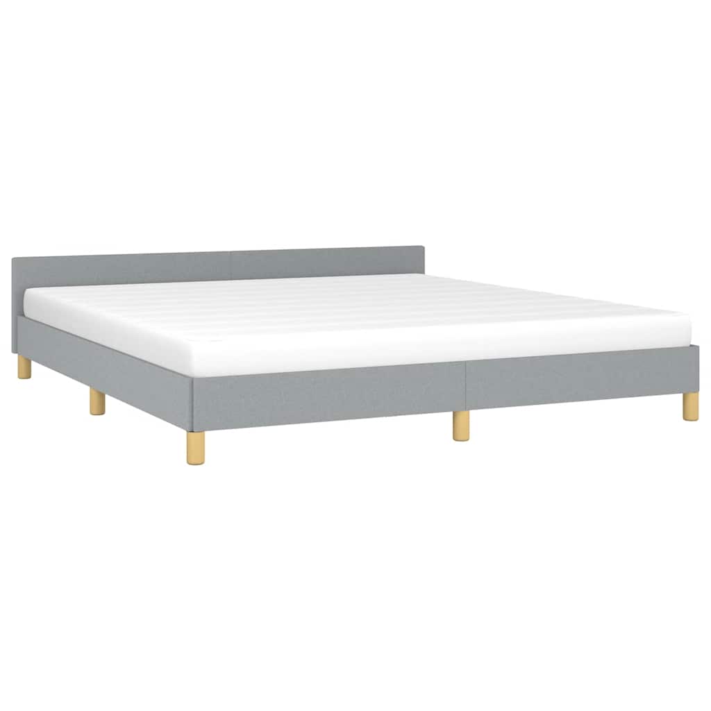 Upholstered grey fabric bed frame with mattress on wooden legs