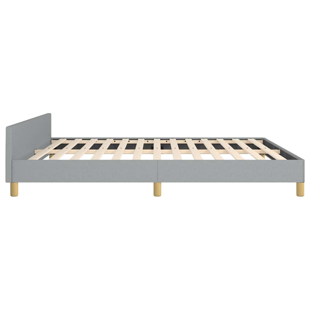 Gray upholstered bed frame with wooden slats and round legs