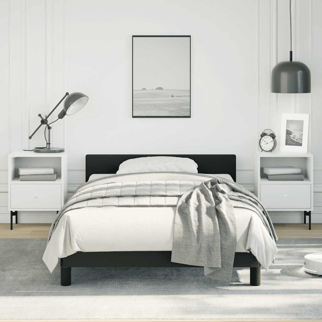 Modern black metal twin bed frame with white bedding