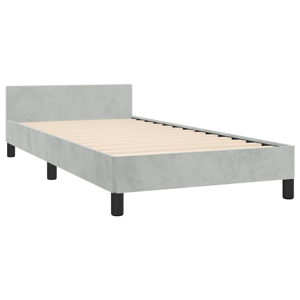 Light gray upholstered twin bed frame with black legs and a white mattress