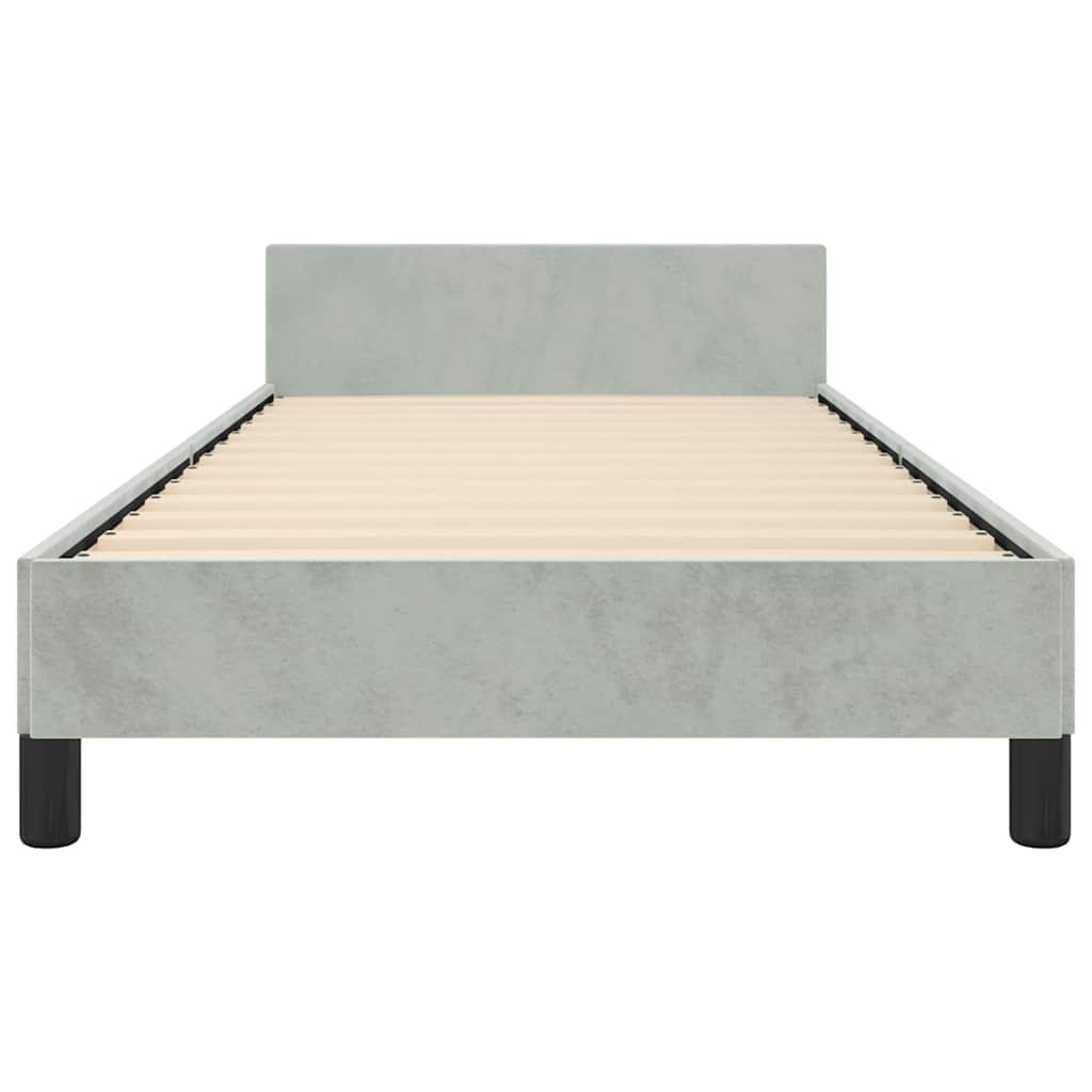 Single bed frame in light green velvet with a white mattress and black legs