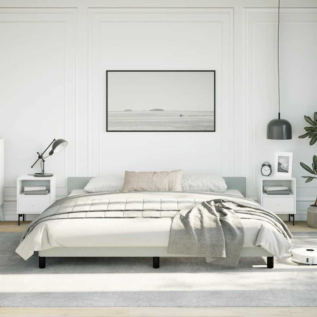 Minimalist platform bed frame in light gray fabric with black legs