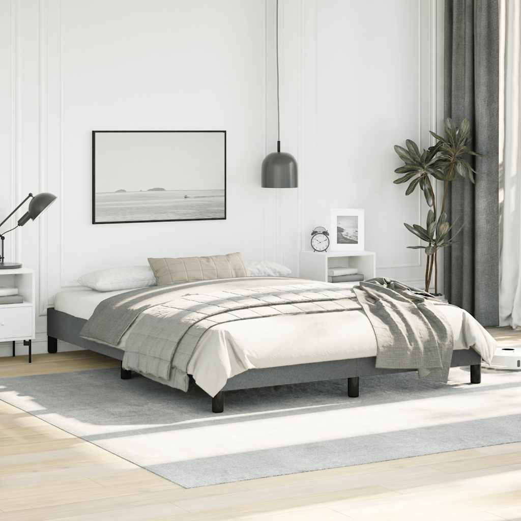 Gray upholstered platform bed frame with wooden slats and black legs