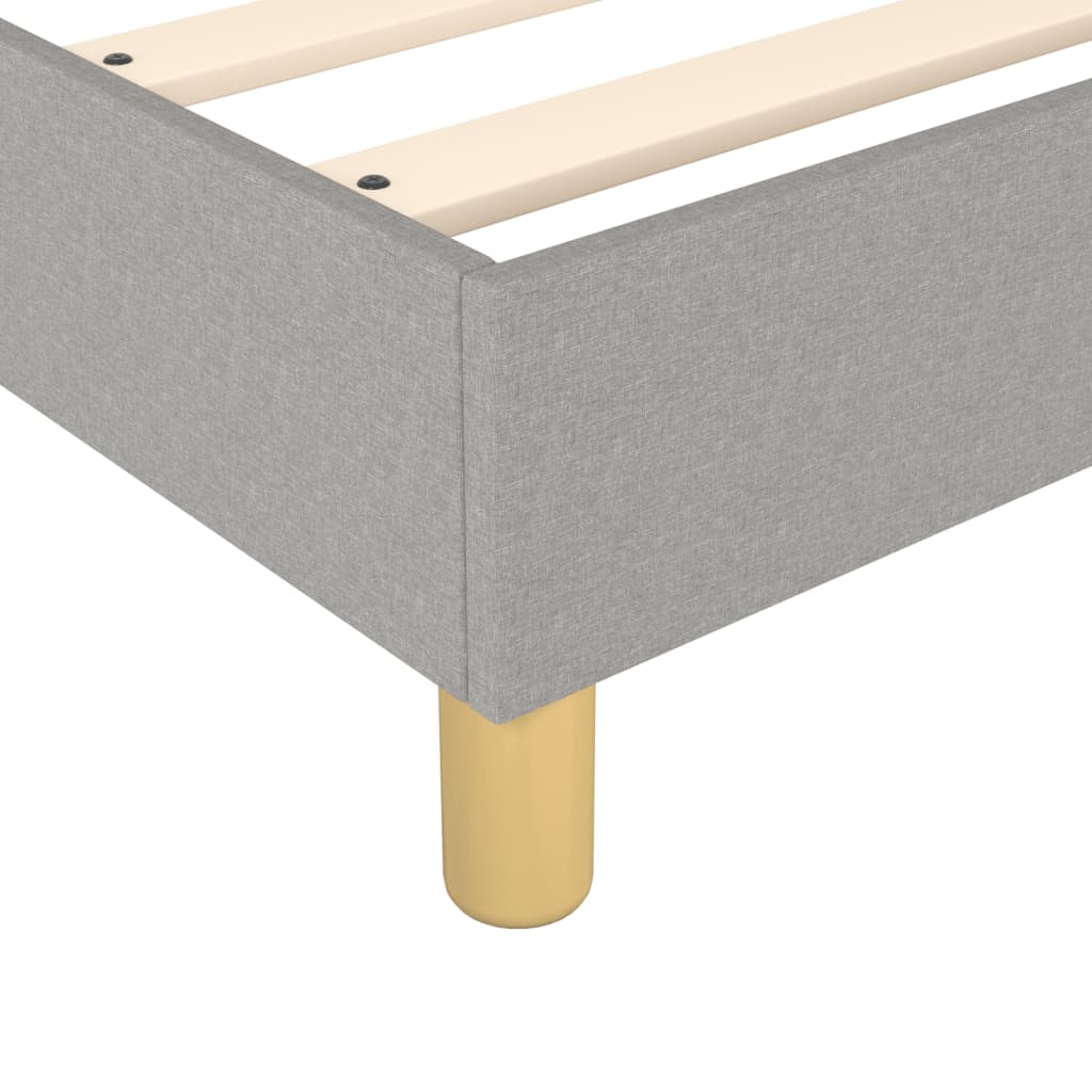 Grey upholstered platform bed frame with wooden slats