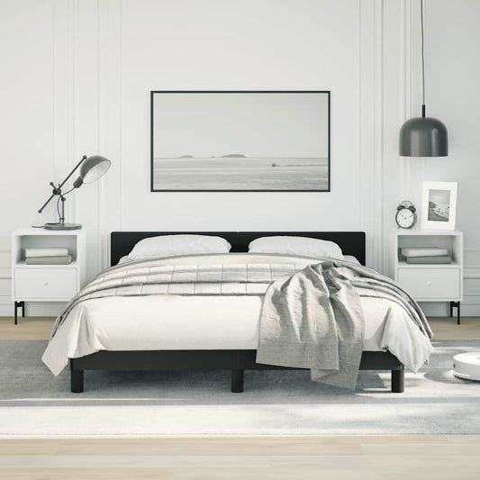 Modern black upholstered queen bed frame with white bedding and gray throw