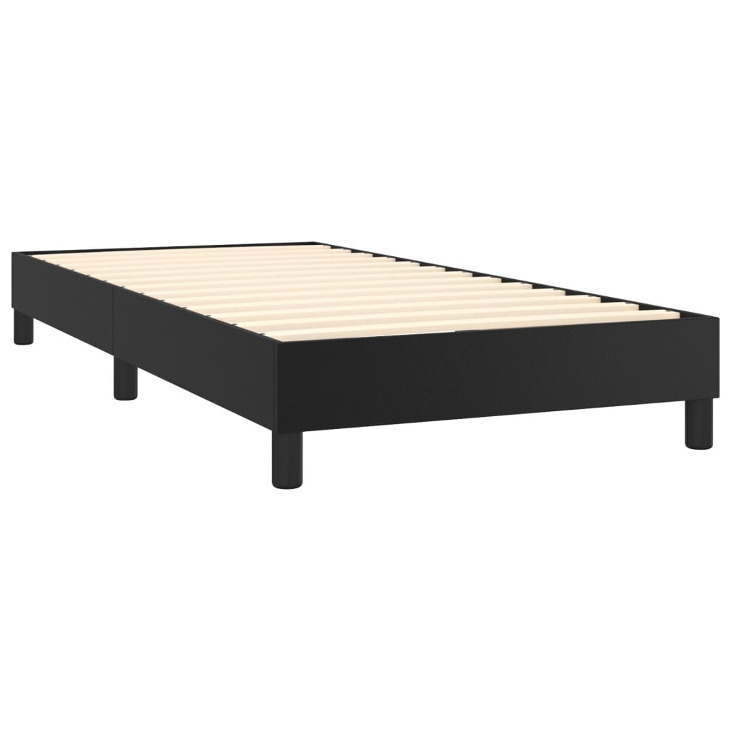 Black upholstered bed frame with white mattress
