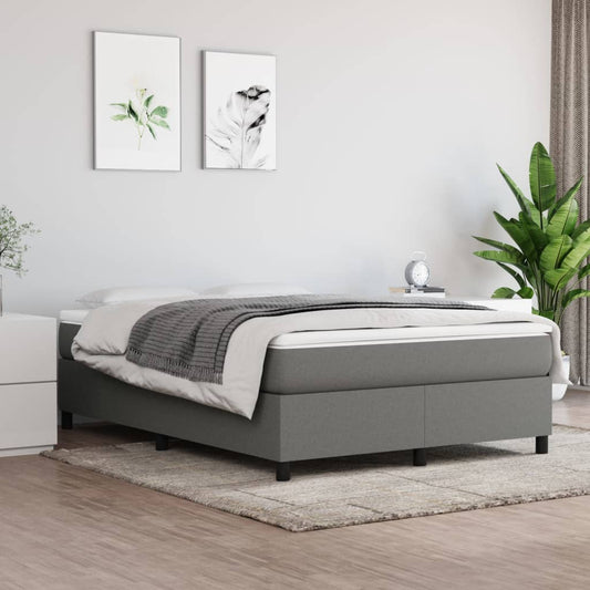 Grey upholstered divan bed with a white mattress and grey throw