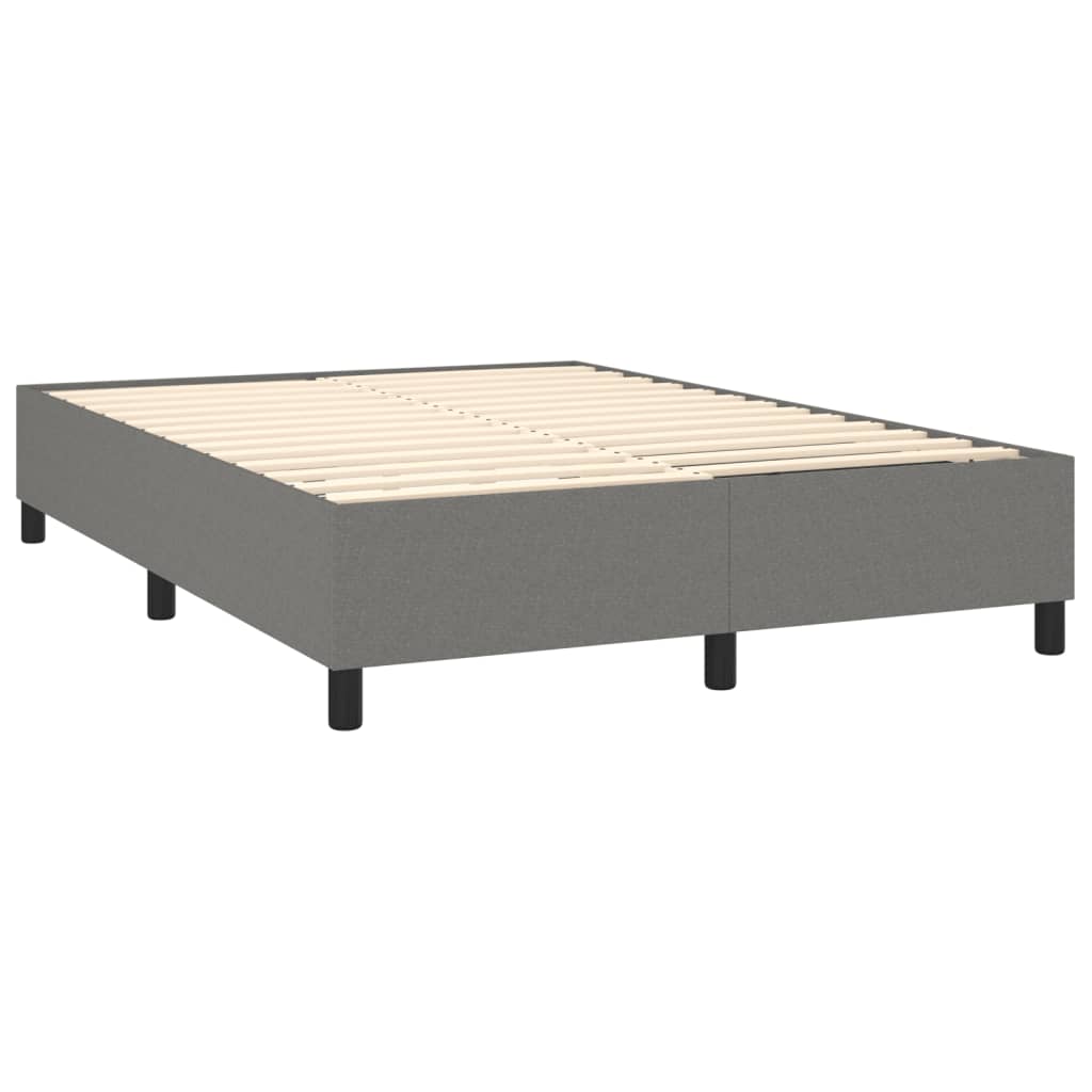 Grey upholstered divan bed with white mattress on black legs