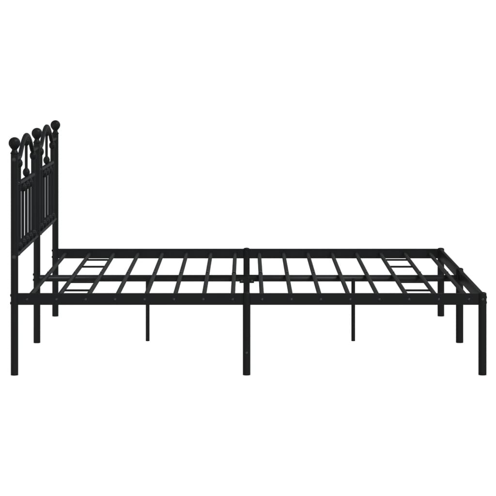 Black metal bed frame with ornate headboard and mattress