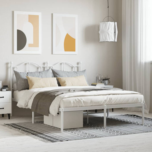 White metal twin bed frame with ornate headboard and footboard featuring upholstered mattress and bedding
