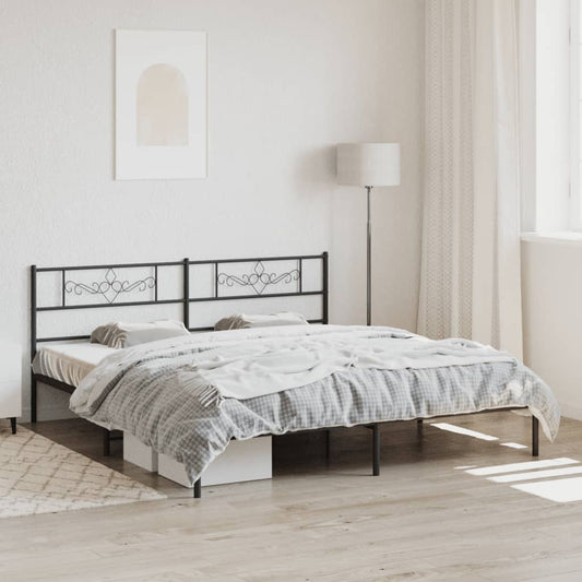 Black metal bed frame with ornate headboard and upholstered mattress
