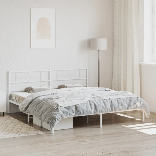 White metal king size bed frame with ornate headboard