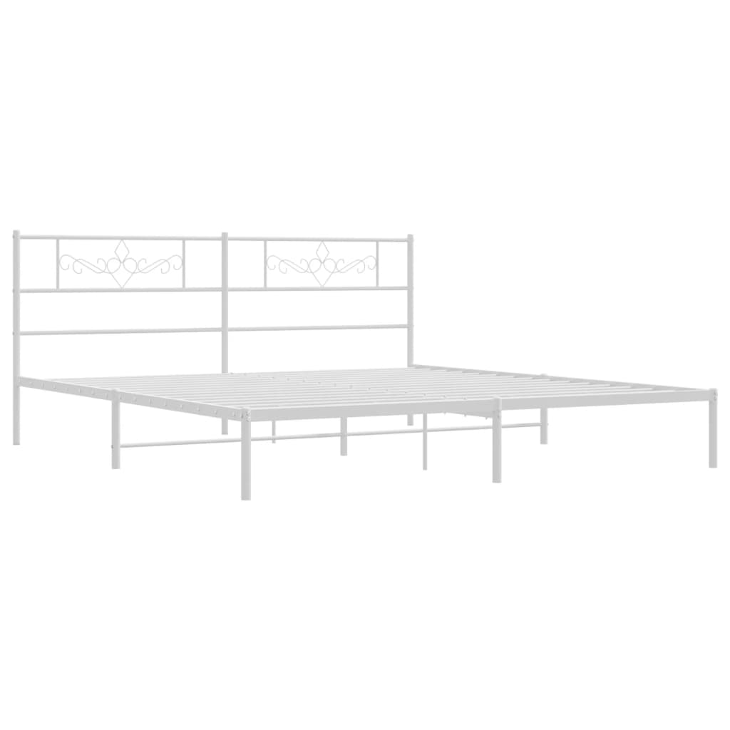 White metal bed frame with decorative headboard and mattress