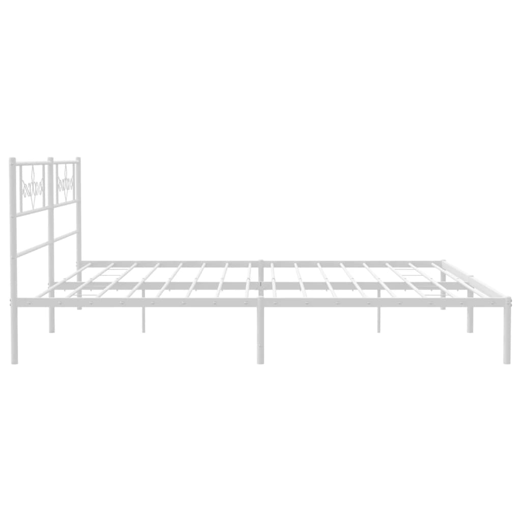 White metal bed frame with ornate headboard and mattress