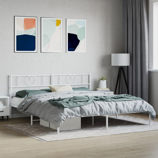 White metal bed frame with heart accents and upholstered mattress