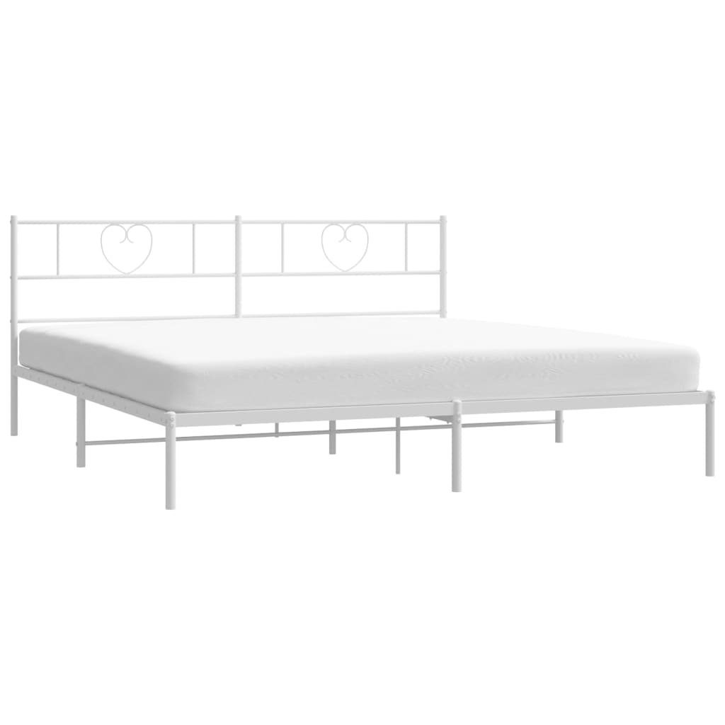 White metal bed frame with heart headboard and mattress