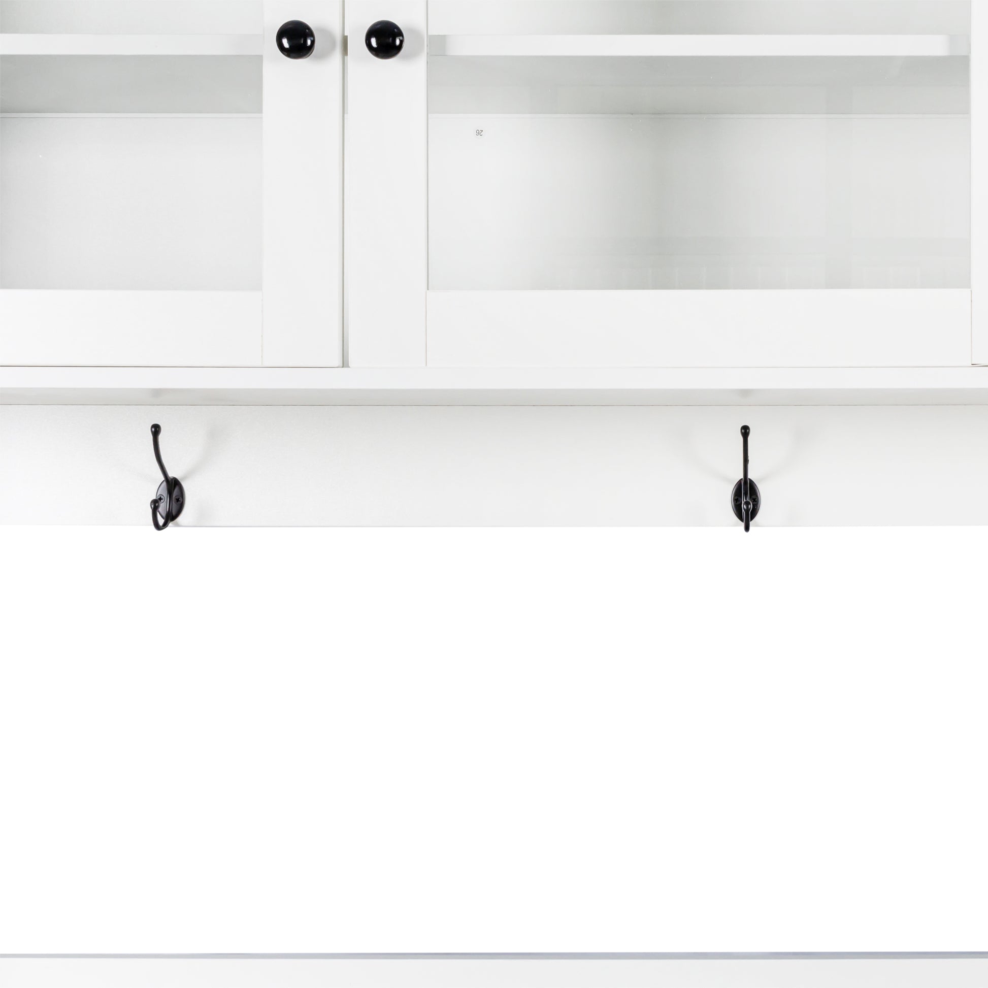 White cabinet with glass doors and black knobs