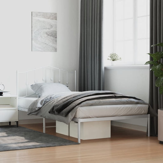 White metal twin bed frame with ornate headboard and footboard