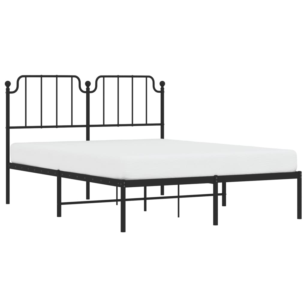 Black metal bed frame with a vintageinspired headboard and white mattress