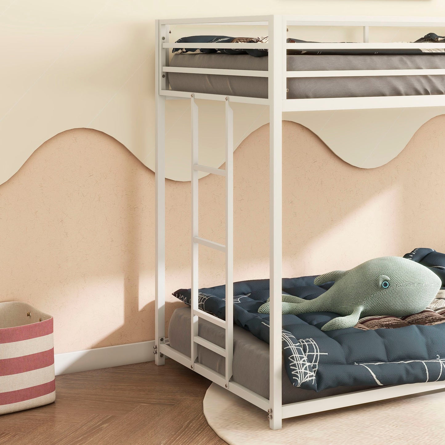 White metal twin over twin bunk bed with gray mattresses and navy patterned bedding