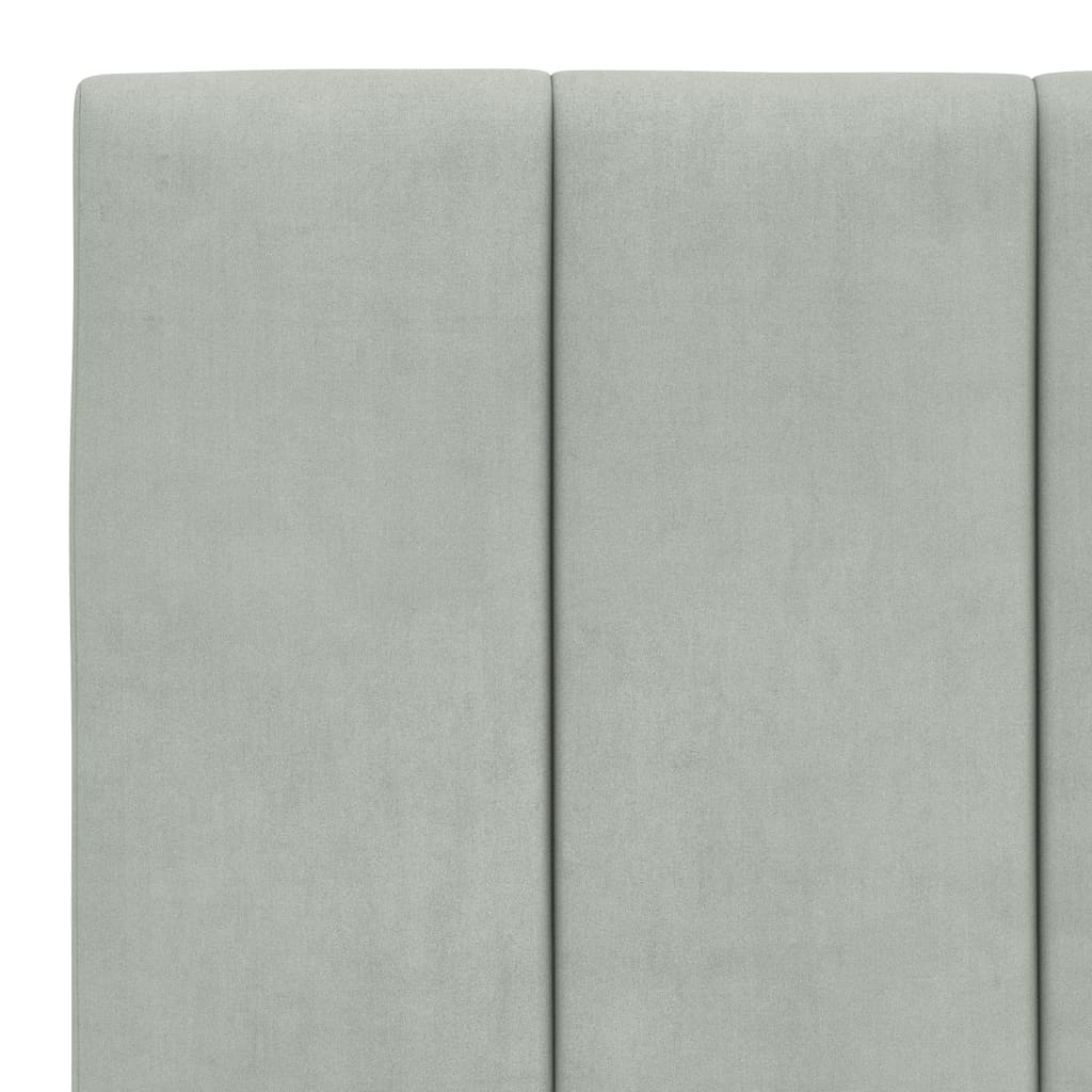 Light gray fabric headboard with tufted top and integrated pocket