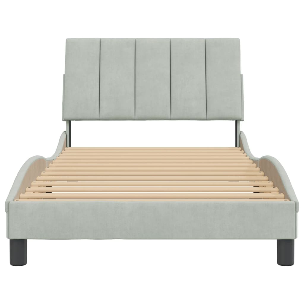 Light blue upholstered twin bed frame with curved headboard and wooden slats