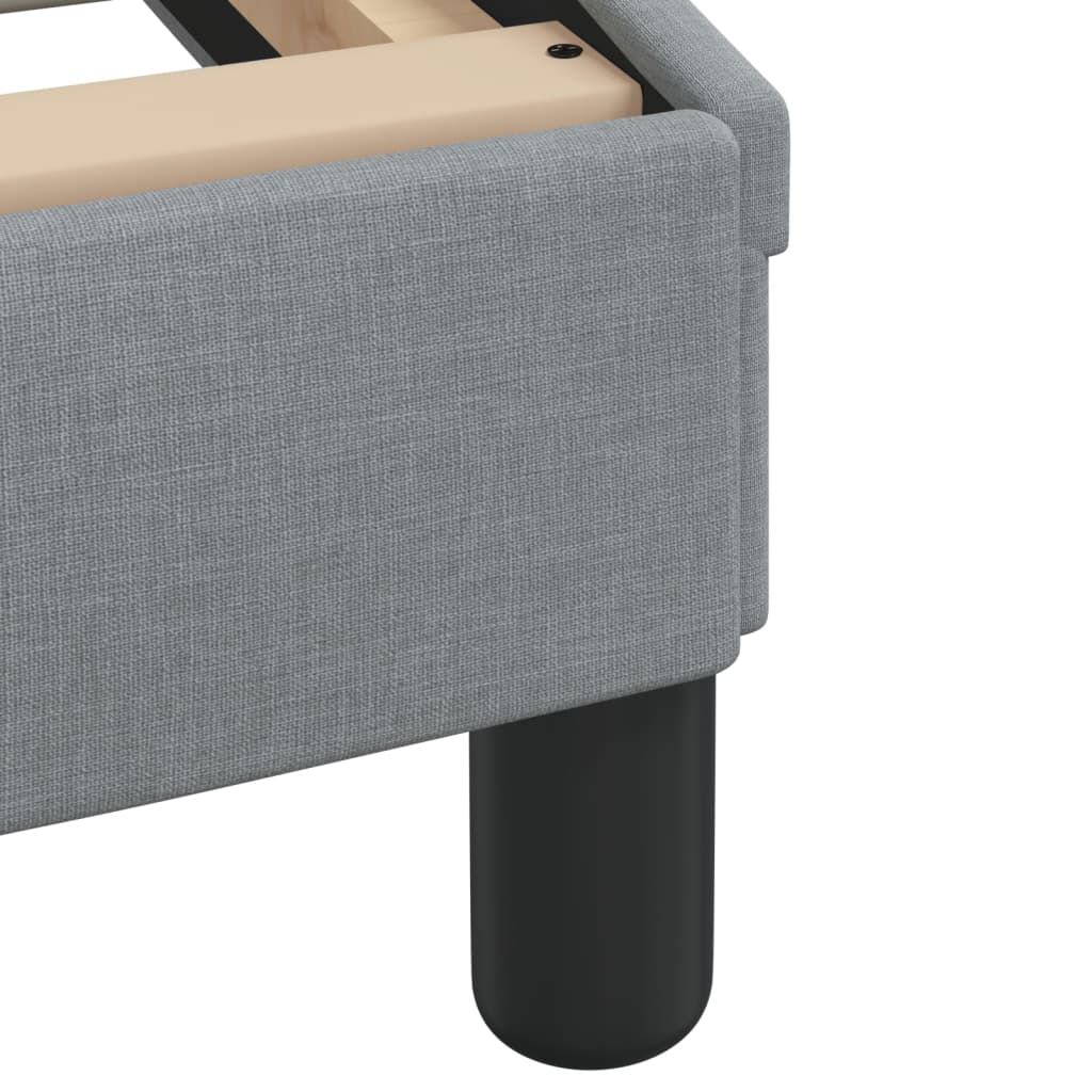 Gray upholstered bed frame with wooden slats and a curved headboard