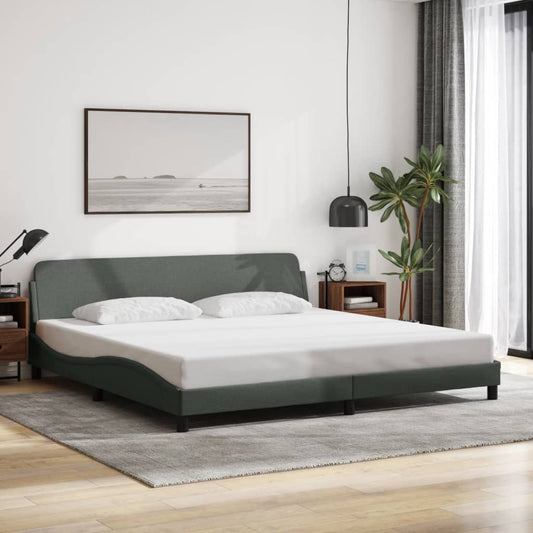 Dark grey upholstered bed frame with a curved headboard and white bedding