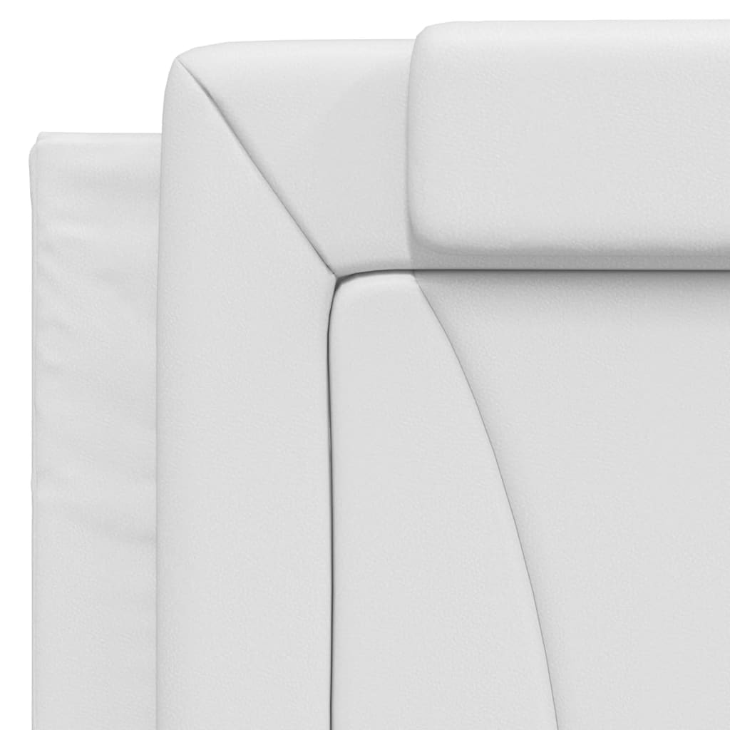 White upholstered bed frame with wooden slats and a layered headboard
