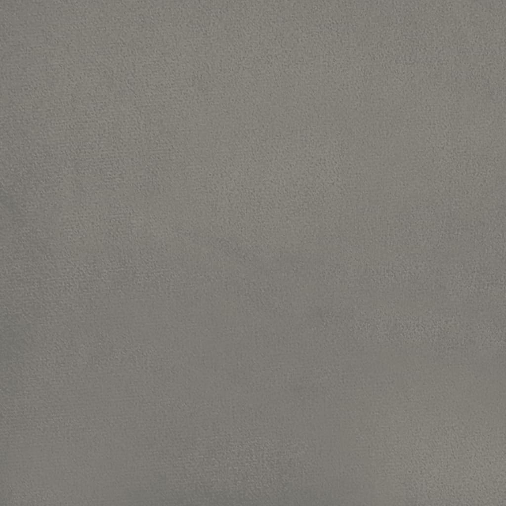 Closeup of a grey fabric upholstered bed frame with wooden slats and black legs