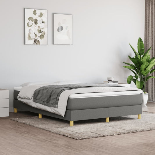 Grey upholstered divan bed base with wooden legs and white mattress