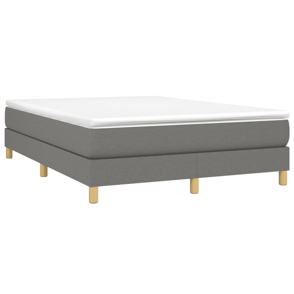 Grey upholstered divan bed base with white mattress and wooden legs