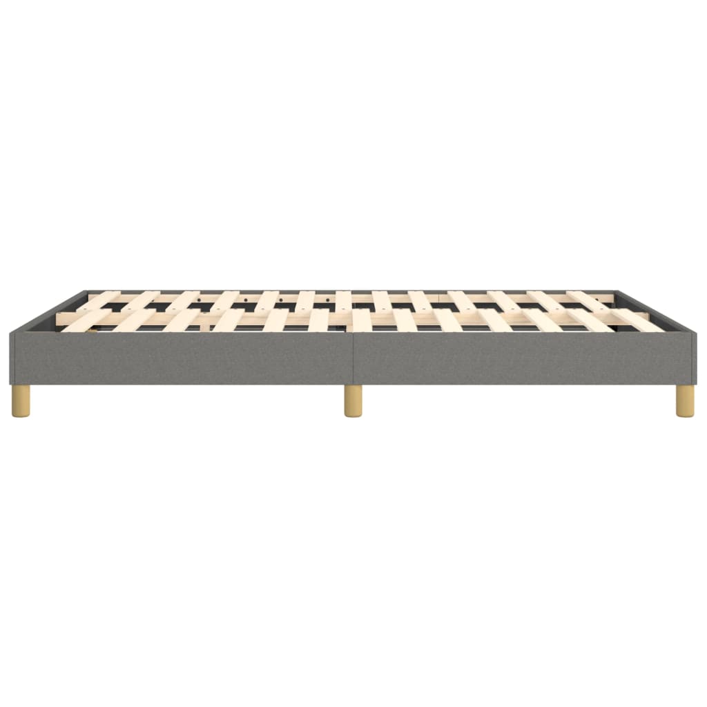Gray upholstered bed frame with wooden slats and short natural wood legs