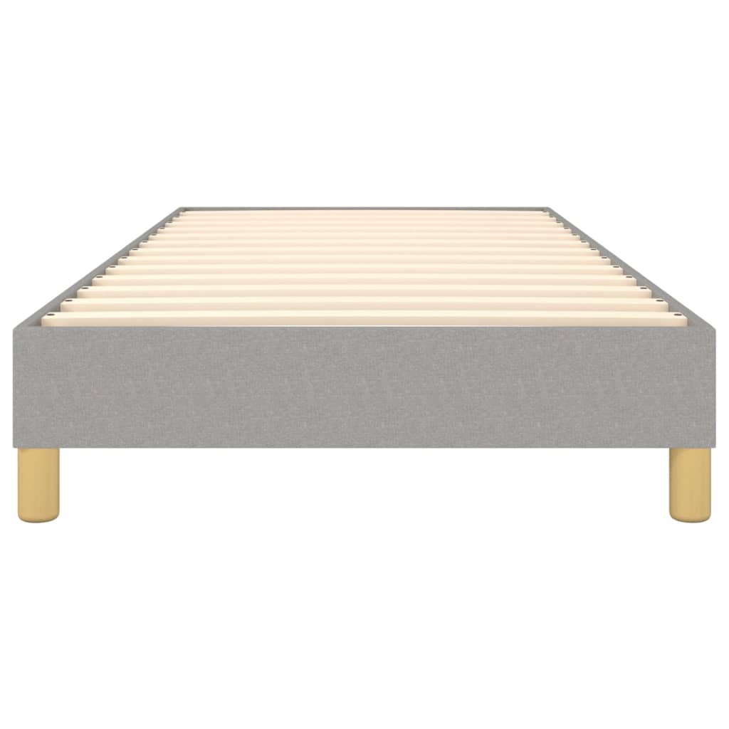 Grey upholstered bed frame with wooden slats and pine legs